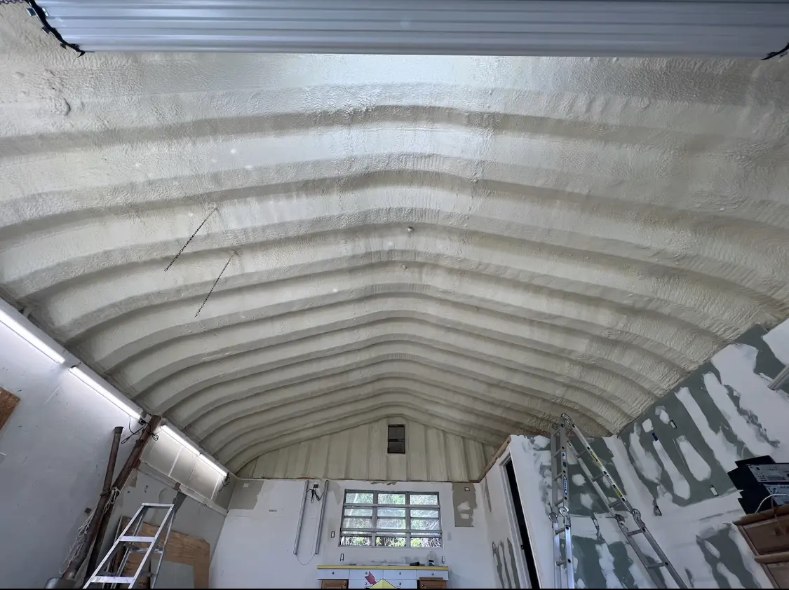 Spray polyurethane foam applied to the underside of a metal roof deck in Raleigh